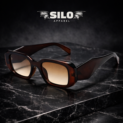 Sunglasses with brown lenses on a dark marble surface, featuring the 'Silo Apparel' brand.