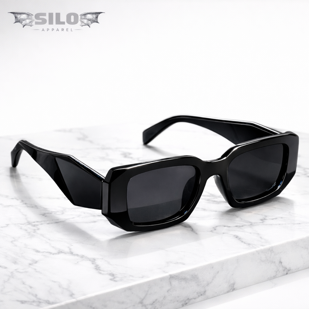 Black sunglasses on a marble surface with 'Silo Apparel' branding.