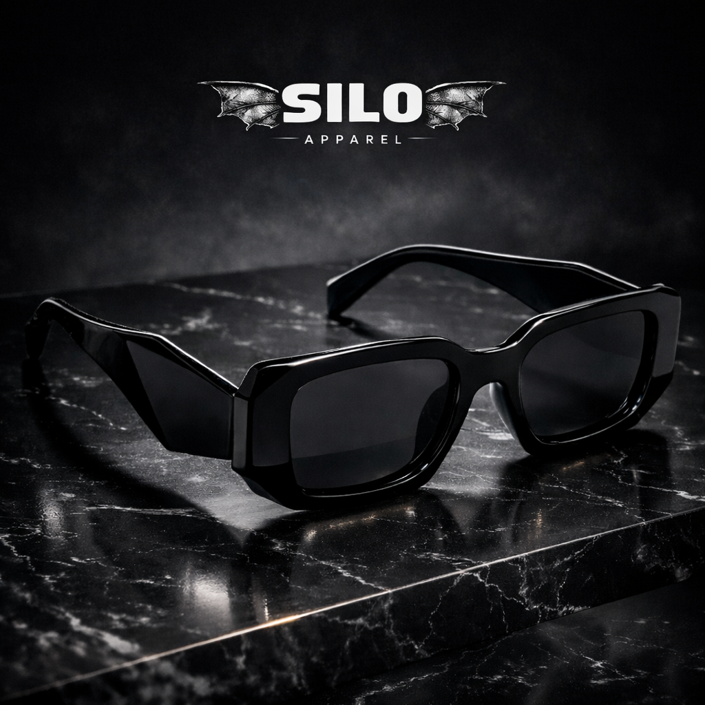 Black sunglasses on a reflective surface with 'Silo Apparel' logo above