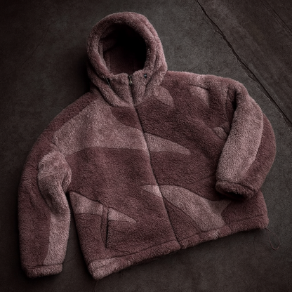 pink fleece jacket on a dark textured surface