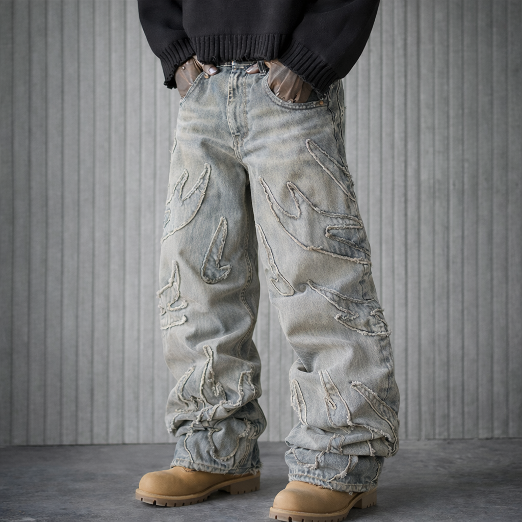 Person wearing distressed light blue jeans with a textured gray background