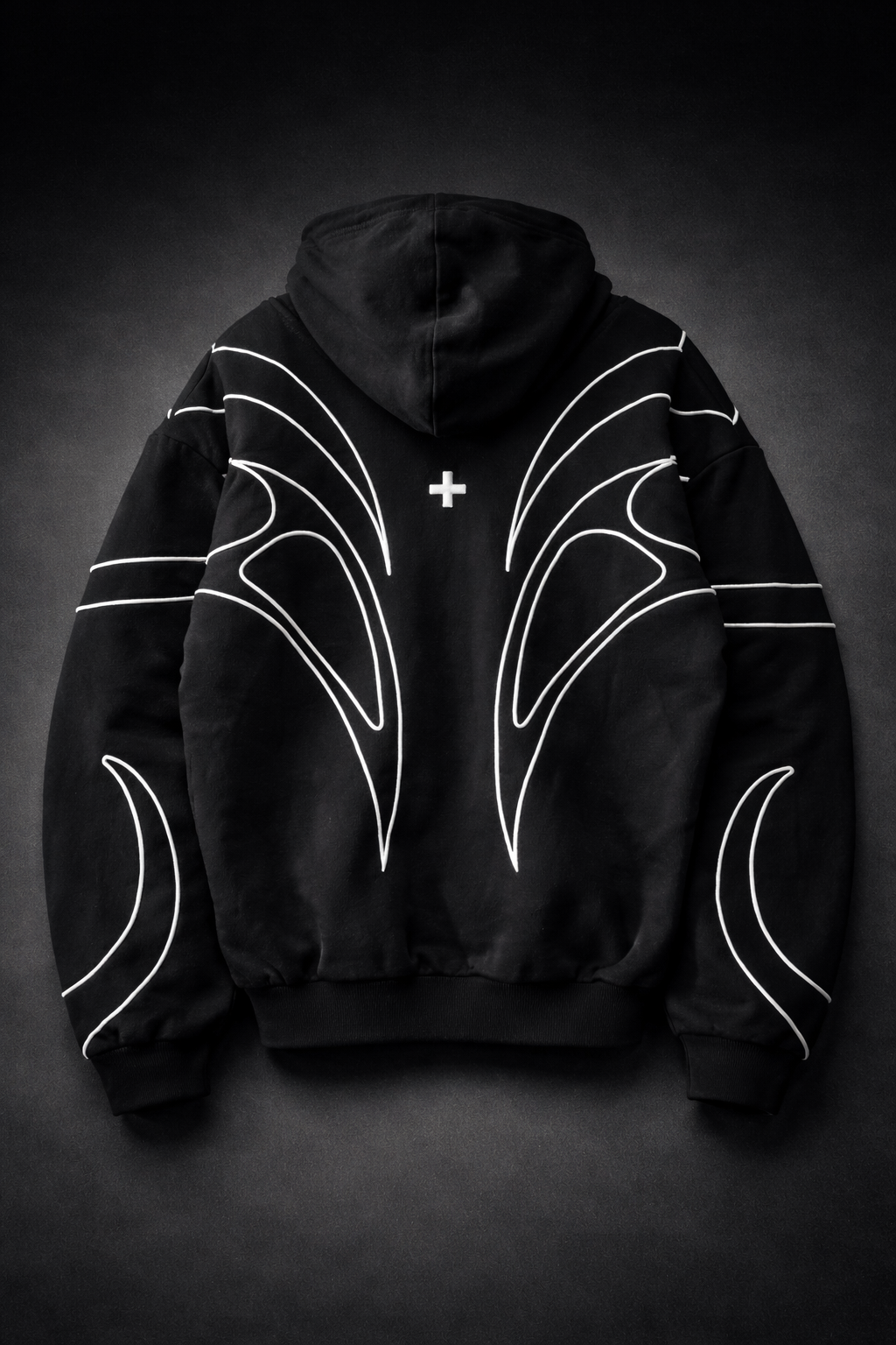 Black hoodie with white designs on a dark background