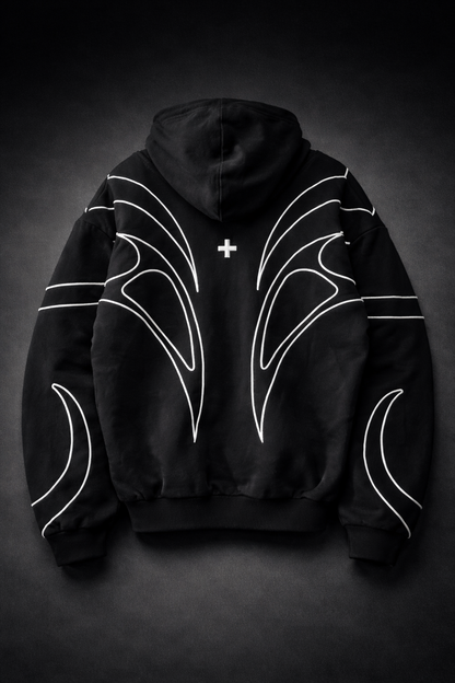 Black hoodie with white designs on a dark background